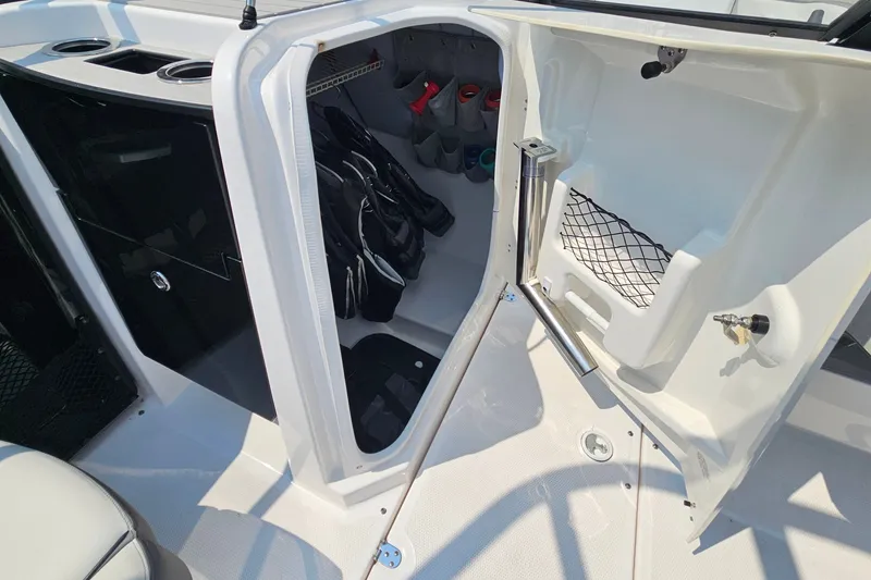 Slide: The Image of 2023 Yamaha AR250 boat storage compartment with gear and accessories. - 17