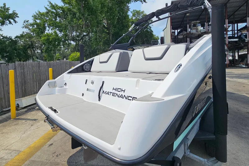 Slide: The Image of 2023 Yamaha Boats AR250 on trailer, showcasing sleek design and spacious seating. - 5