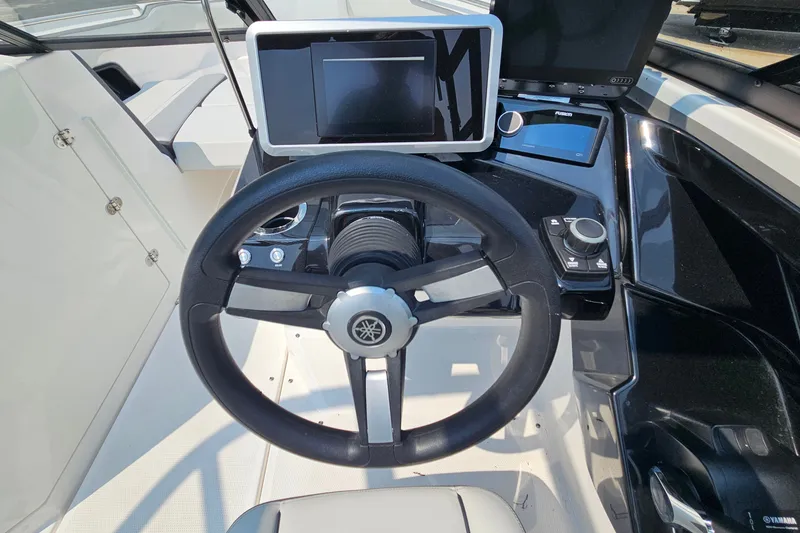 Slide: The Image of 2023 Yamaha Boats AR250 dashboard with steering wheel and modern controls. - 23