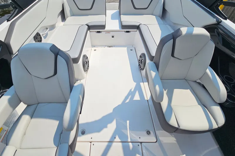 Slide: The Image of 2023 Yamaha Boats AR250 interior with sleek white seating and modern design. - 24