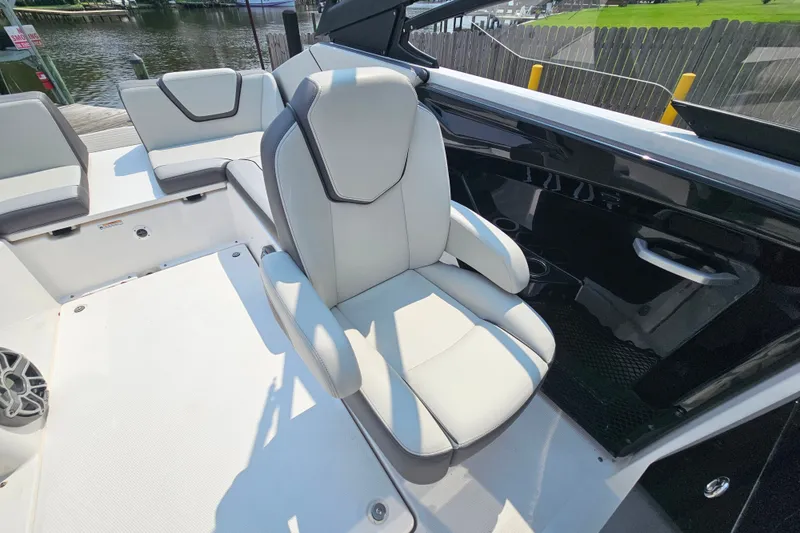 Slide: The Image of 2023 Yamaha Boats AR250 interior with white seating and sleek design. - 20