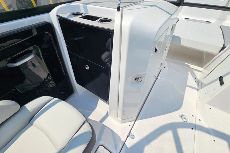 Slide: The Image of 2023 Yamaha Boats AR250 interior with seating, storage, and cup holders. - 19