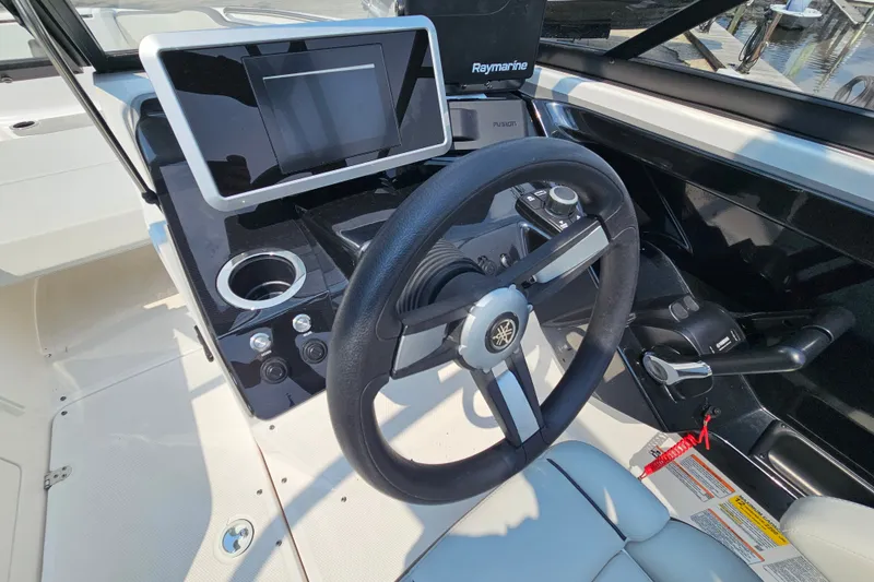 Slide: The Image of 2023 Yamaha Boats AR250 dashboard with steering wheel and touchscreen display. - 22