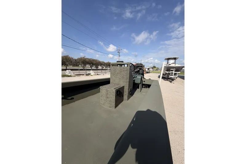 Slide: The Image of 2019 Patriot 2054 boat on pavement under clear blue sky. - 9