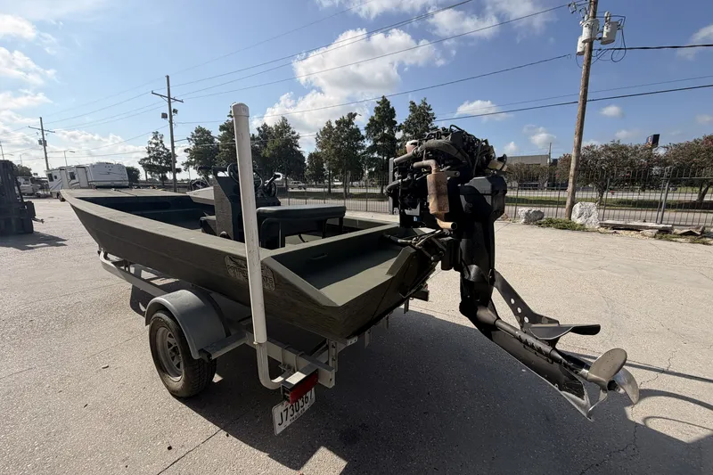 Slide: The Image of 2019 Patriot 2054 boat on trailer with outboard motor, parked outdoors. - 4