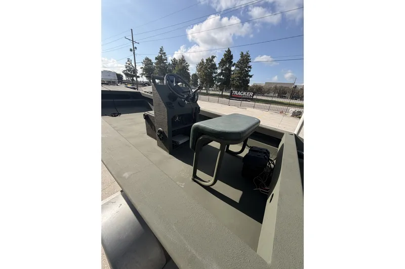 Slide: The Image of 2019 Patriot 2054 boat interior with steering console and seat under a clear sky. - 5