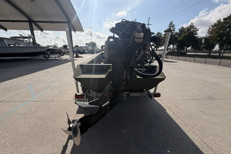 Slide: The Image of 2019 Patriot 2054 boat with outboard motor on trailer in sunny outdoor setting. - 3