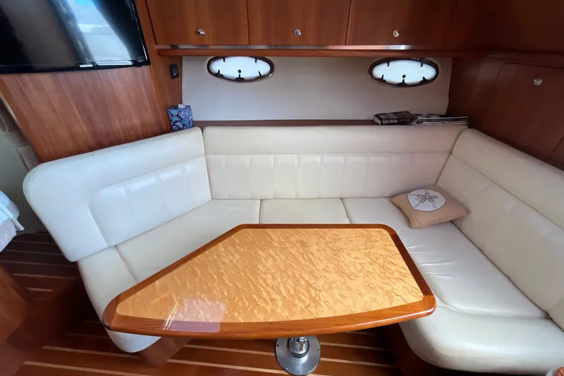 Slide: The Image of Luxurious interior of 2006 Tiara 32 OPEN yacht with elegant seating and wooden table. - 7