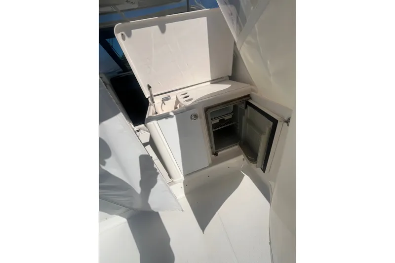 Slide: The Image of 2006 Tiara 32 OPEN yacht interior with open mini fridge and storage compartment. - 11