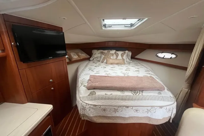 Slide: The Image of Luxurious cabin interior of 2006 Tiara 32 OPEN yacht with cozy bed and TV. - 17