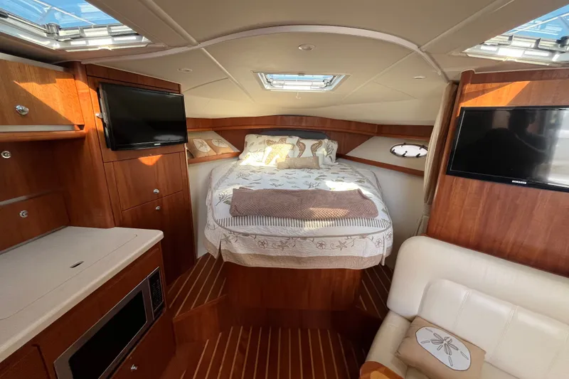 Slide: The Image of Luxurious 2006 Tiara 32 OPEN yacht interior with cozy bed, wood finish, and modern amenities. - 8