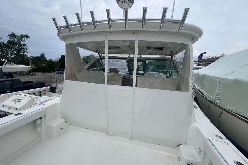Slide: The Image of 2006 Tiara 32 OPEN boat with covered cockpit and fishing rod holders. - 6