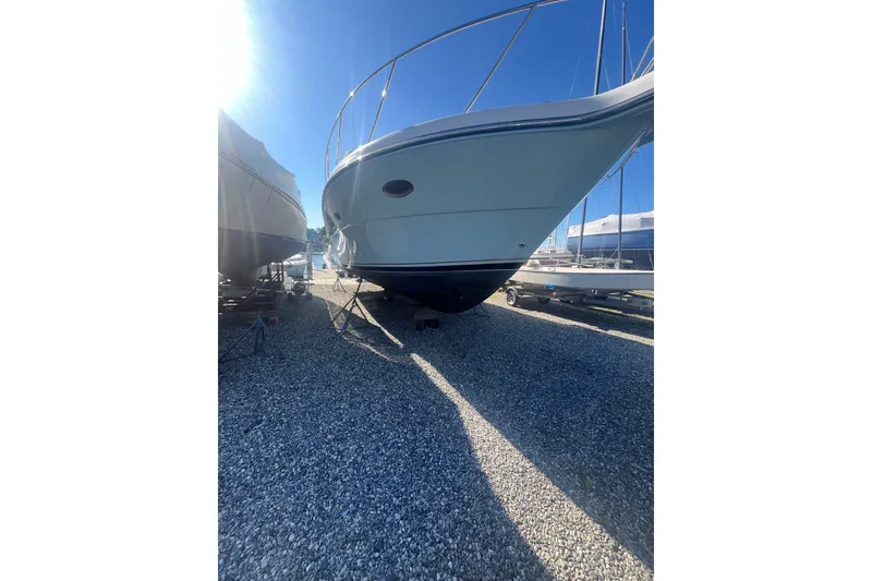 Slide: The Image of 2006 Tiara 32 OPEN boat on gravel, under bright sunlight. - 12
