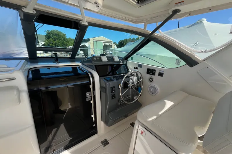 Slide: The Image of Interior view of a 2006 Tiara 32 OPEN boat cockpit with steering wheel and controls. - 10