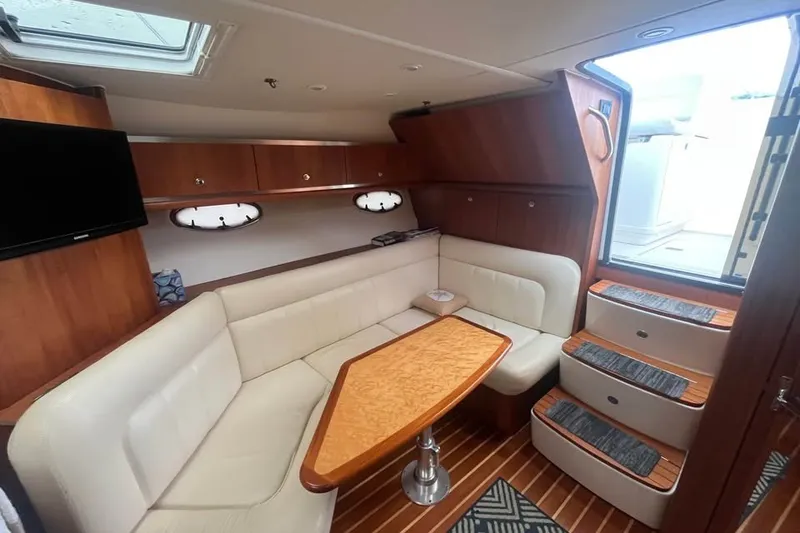 Slide: The Image of Interior of 2006 Tiara 32 OPEN yacht with cozy seating and wooden accents. - 14