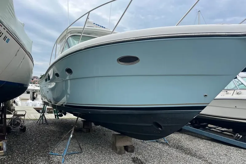 Slide: The Image of 2006 Tiara 32 OPEN boat on stands, displayed outdoors on gravel. - 3