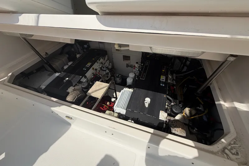 Slide: The Image of Engine compartment of a 2006 Tiara 32 OPEN boat, showcasing dual engines and mechanical components. - 15
