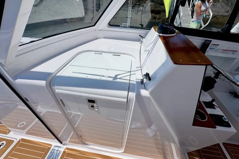 Slide: The Image of 2024 Southport 33 DC boat interior with sleek white cabinetry and wood accents. - 22
