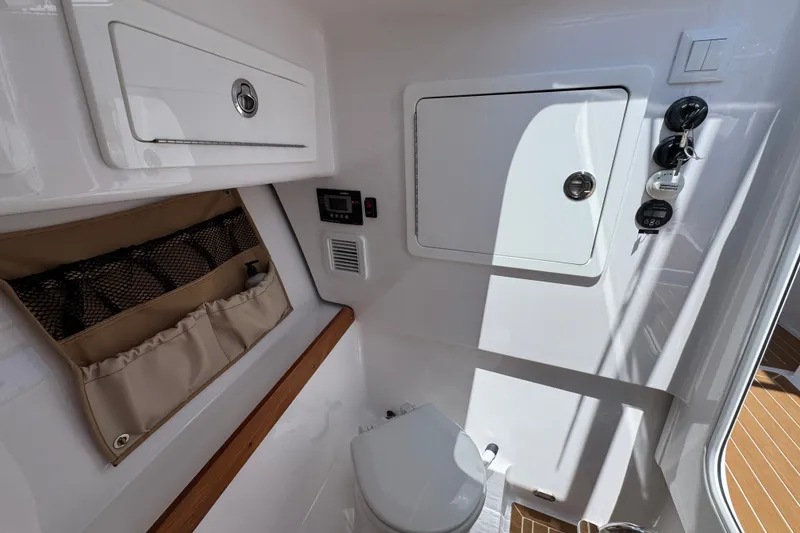 Slide: The Image of 2024 Southport 33 DC boat interior with storage compartments and modern amenities. - 24