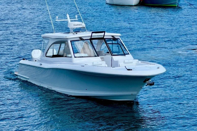 Slide: The Image of 2024 Southport 33 DC boat cruising on clear blue water. - 5
