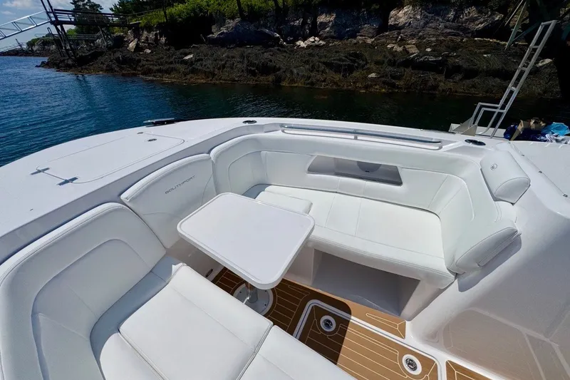 Slide: The Image of Luxurious seating area on 2024 Southport 33 DC boat, featuring white upholstery and a sleek table. - 29