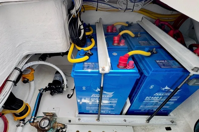 Slide: The Image of 2024 Southport 33 DC boat battery compartment with blue DC400-6 batteries and wiring. - 32