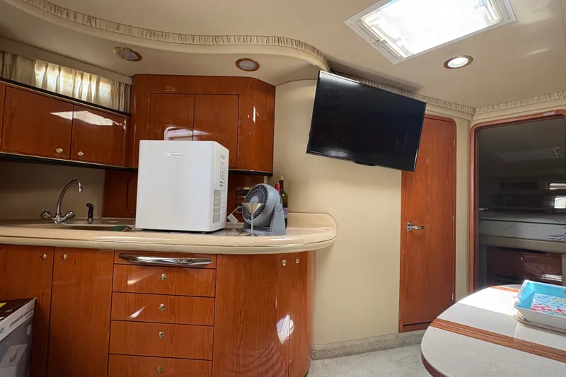 Slide: The Image of Interior of 2001 Sea Ray Sundancer 460 yacht with kitchenette and mounted TV. - 26