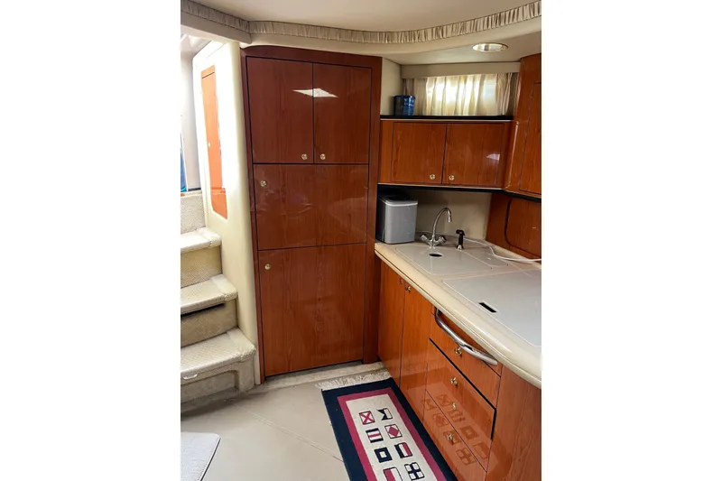 Slide: The Image of Interior of 2001 Sea Ray Sundancer 460 yacht kitchen with wooden cabinets and sink. - 39