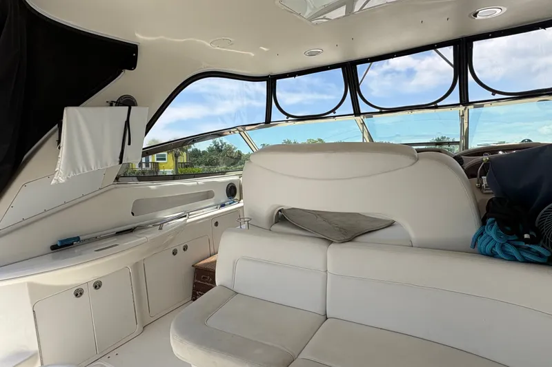 Slide: The Image of Interior of 2001 Sea Ray Sundancer 460 yacht with white seating and panoramic windows. - 22