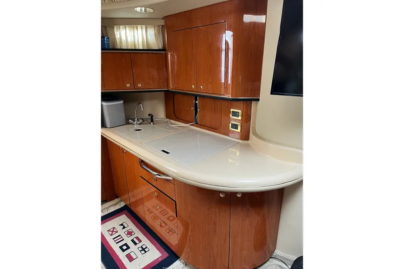 Slide: The Image of Luxurious 2001 Sea Ray Sundancer 460 yacht kitchen with sleek wood cabinetry and modern amenities. - 44
