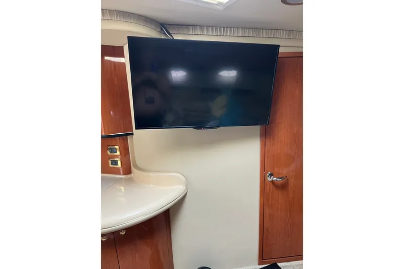 Slide: The Image of Flat-screen TV in 2001 Sea Ray Sundancer 460 yacht interior with wood cabinetry. - 43