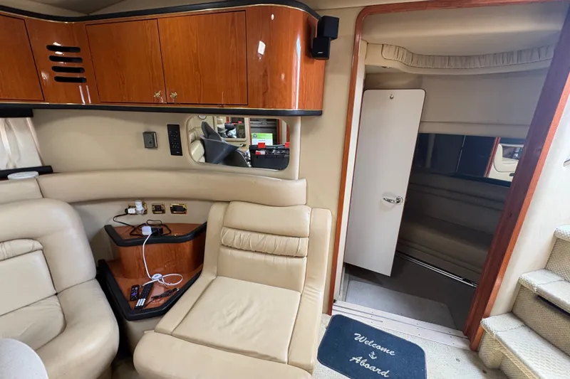 Slide: The Image of Interior of 2001 Sea Ray Sundancer 460 yacht with beige seating and wooden cabinetry. - 7