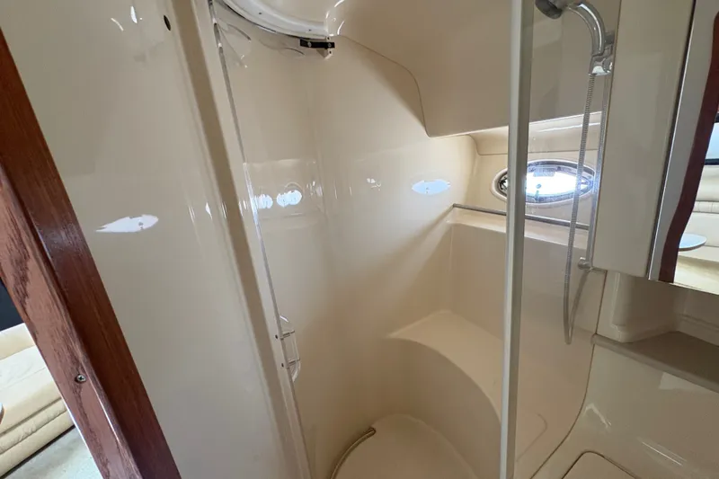 Slide: The Image of 2001 Sea Ray Sundancer 460 yacht bathroom with shower and porthole window. - 25
