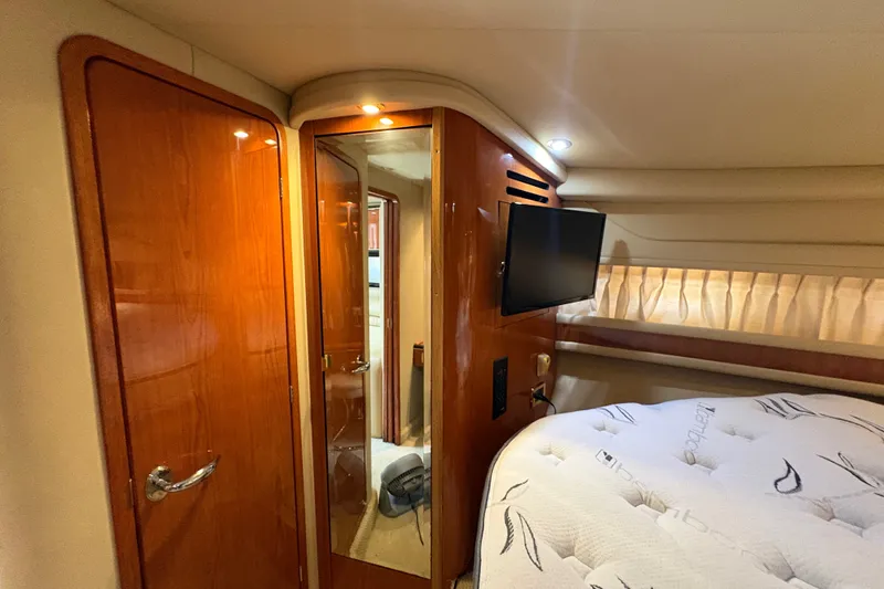 Slide: The Image of Interior cabin of 2001 Sea Ray Sundancer 460 yacht with wood paneling and TV. - 19