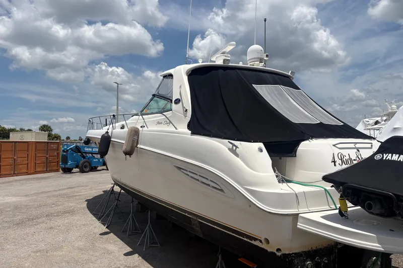 Slide: The Image of 2001 Sea Ray Sundancer 460 yacht on stands, under a cloudy sky. - 4