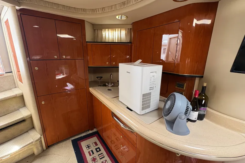 Slide: The Image of Luxurious 2001 Sea Ray Sundancer 460 yacht interior with kitchenette and wooden cabinetry. - 8