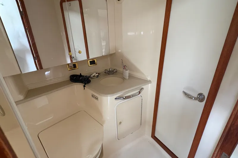 Slide: The Image of Bathroom interior of 2001 Sea Ray Sundancer 460 yacht, featuring sink and storage cabinets. - 10