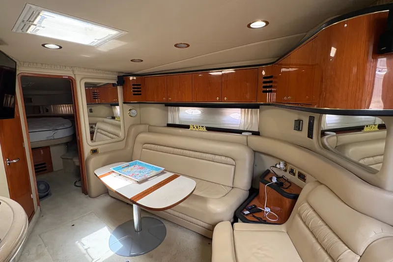 Slide: The Image of Luxurious interior of 2001 Sea Ray Sundancer 460 yacht with leather seating and wooden cabinetry. - 16