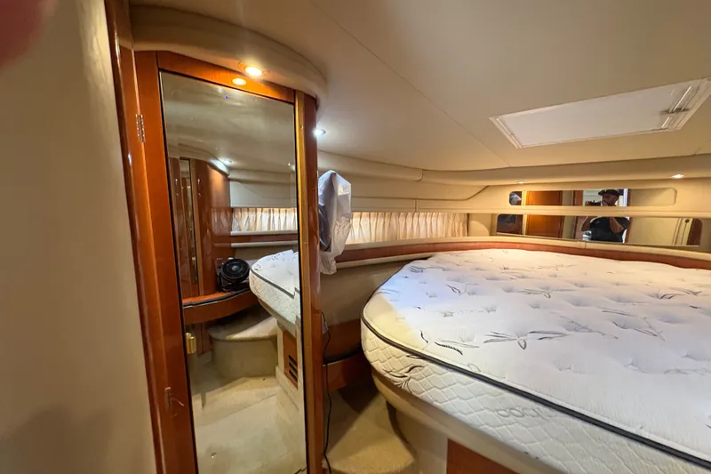 Slide: The Image of Luxurious cabin interior of 2001 Sea Ray Sundancer 460 yacht with plush bedding. - 9