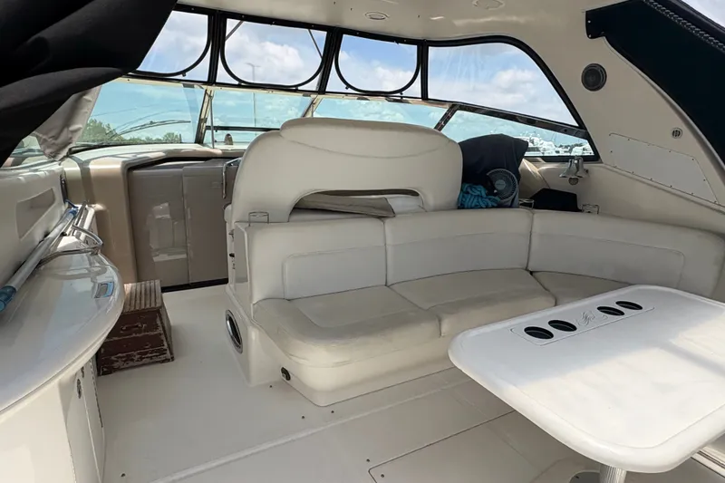 Slide: The Image of Interior of 2001 Sea Ray Sundancer 460 yacht with white seating and table. - 27