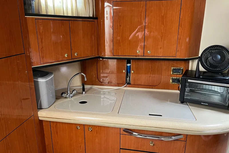 Slide: The Image of Luxurious 2001 Sea Ray Sundancer 460 yacht kitchen with wood cabinets and modern appliances. - 36