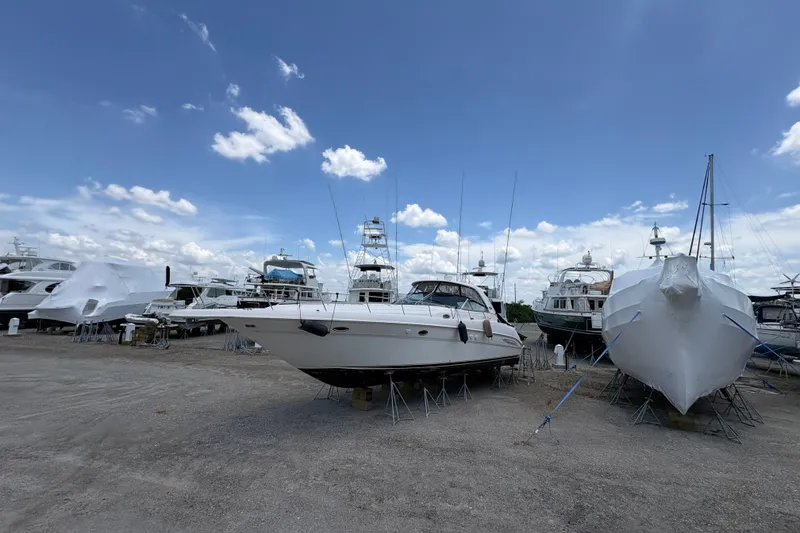 Slide: The Image of 2001 Sea Ray Sundancer 460 yacht on dry dock under a clear blue sky. - 5