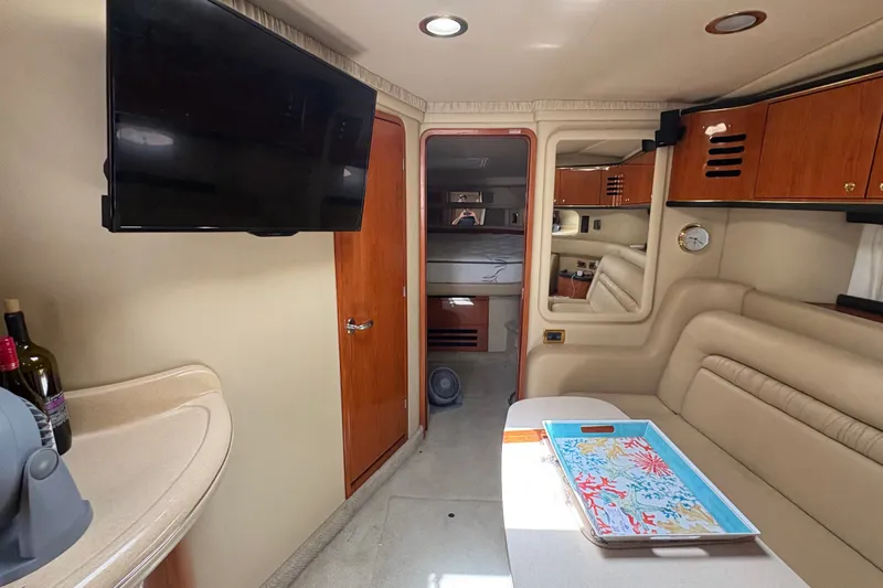 Slide: The Image of Interior of 2001 Sea Ray Sundancer 460 yacht with TV, seating, and table. - 13