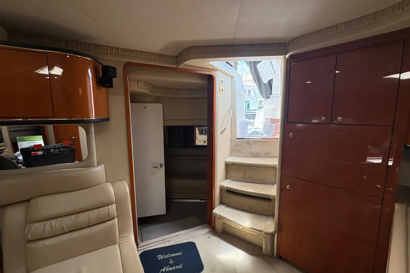 Slide: The Image of Interior of 2001 Sea Ray Sundancer 460 yacht with wooden cabinets and carpeted stairs. - 17