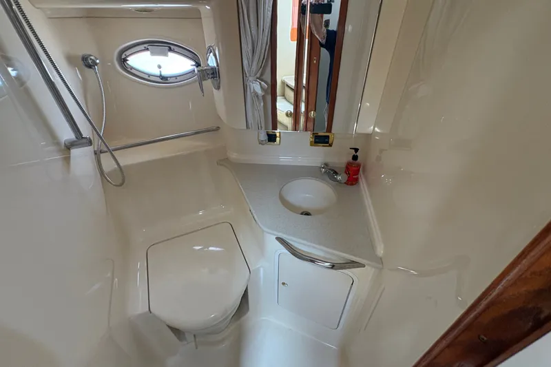 Slide: The Image of Bathroom interior of 2001 Sea Ray Sundancer 460 yacht, featuring sink, toilet, and shower. - 14