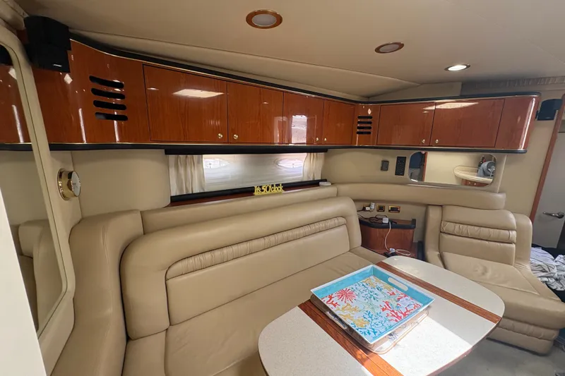 Slide: The Image of Luxurious interior of a 2001 Sea Ray Sundancer 460 yacht with leather seating and wooden cabinetry. - 23