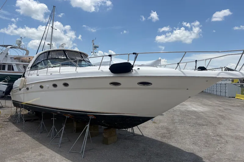 Slide: The Image of 2001 Sea Ray Sundancer 460 yacht on dry dock under a clear blue sky. - 2