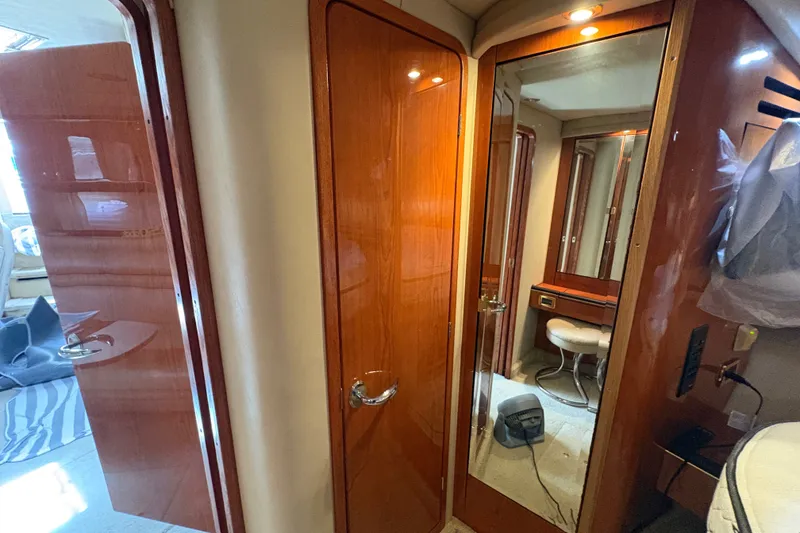 Slide: The Image of Interior of 2001 Sea Ray Sundancer 460 yacht with wooden cabinetry and mirrored door. - 20