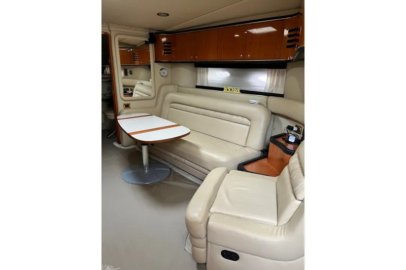 Slide: The Image of Interior of 2001 Sea Ray Sundancer 460 yacht with beige leather seating and wooden cabinetry. - 37