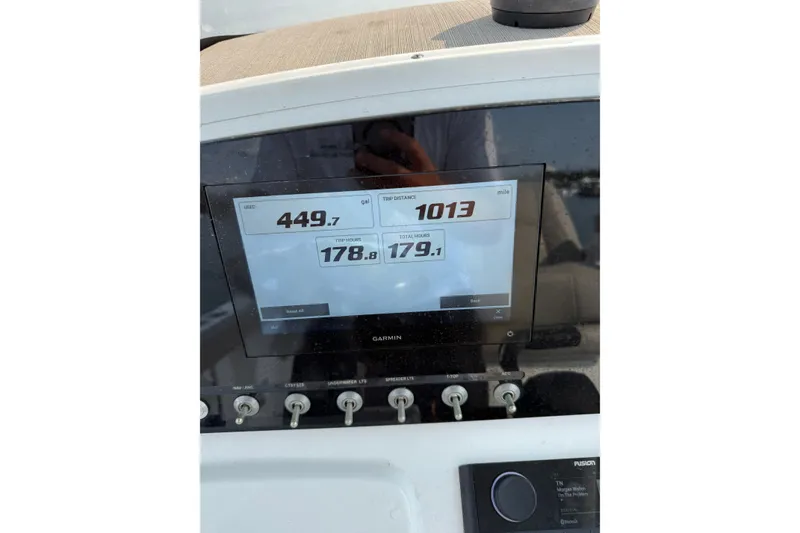 Slide: The Image of 2023 Sportsman Heritage 231 Center Console dashboard with Garmin display showing trip data. - 24